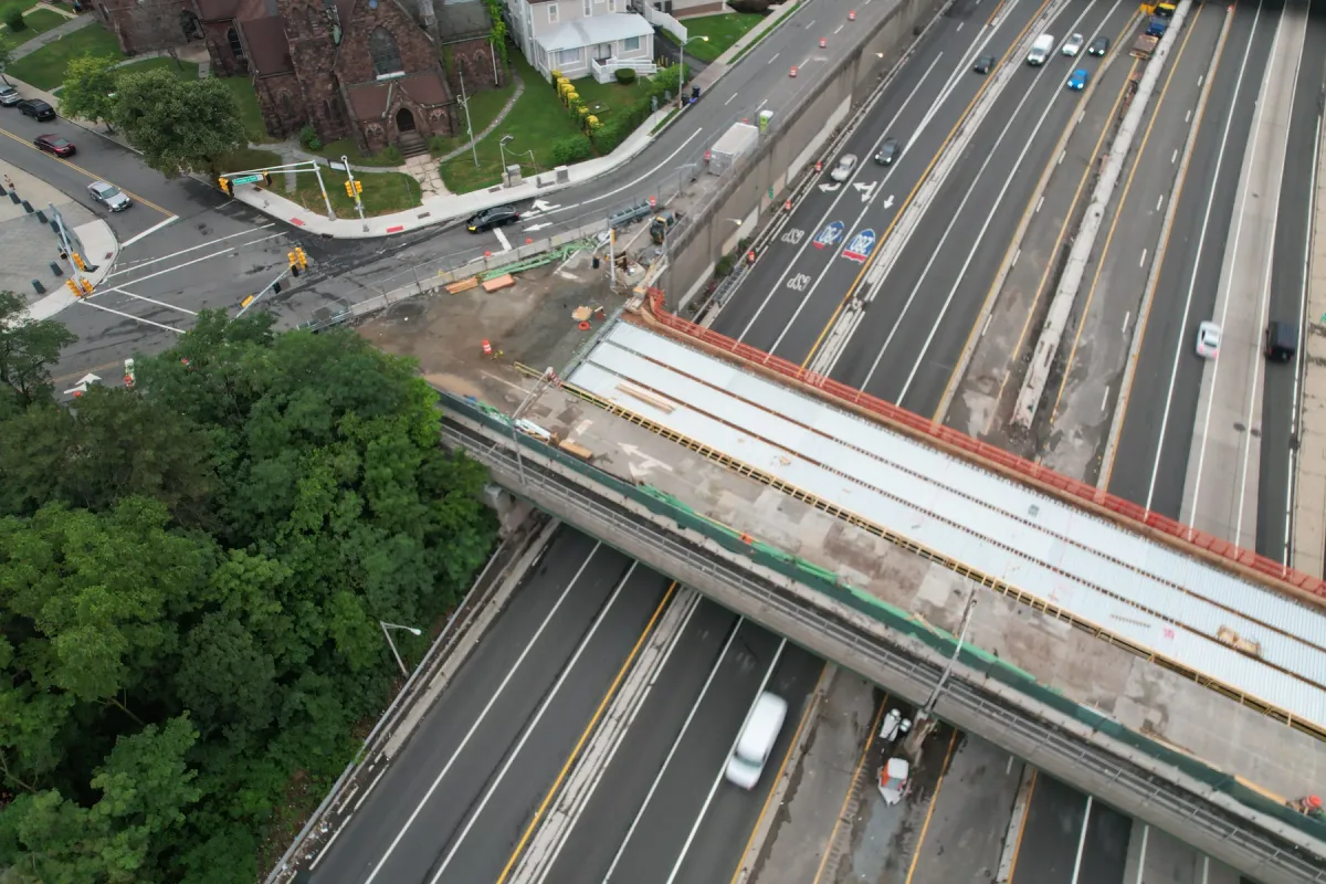 Oblique view of a bridge with construction barriers above a highway